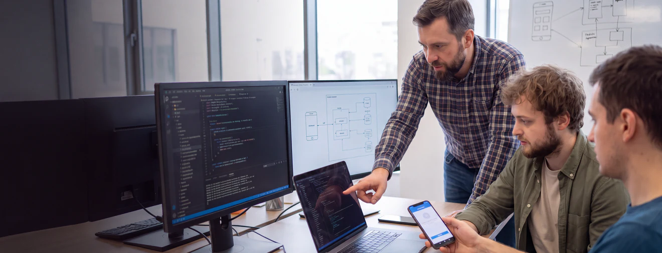 Engineering lead reviewing web and mobile architecture with a team